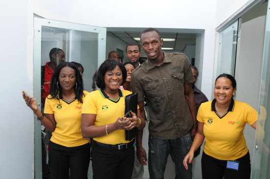 Usain Bolt makes his way through Digicel Jamaica's offices with Shelly-Ann Curran, Paula Pinnock-McLoud and Cheryl Hall -  Negril Travel Guide - Negril, Jamaica WI - NegrilTravelGuide.com - http://www.negriltravelguide.com - info@negriltravelguide.com